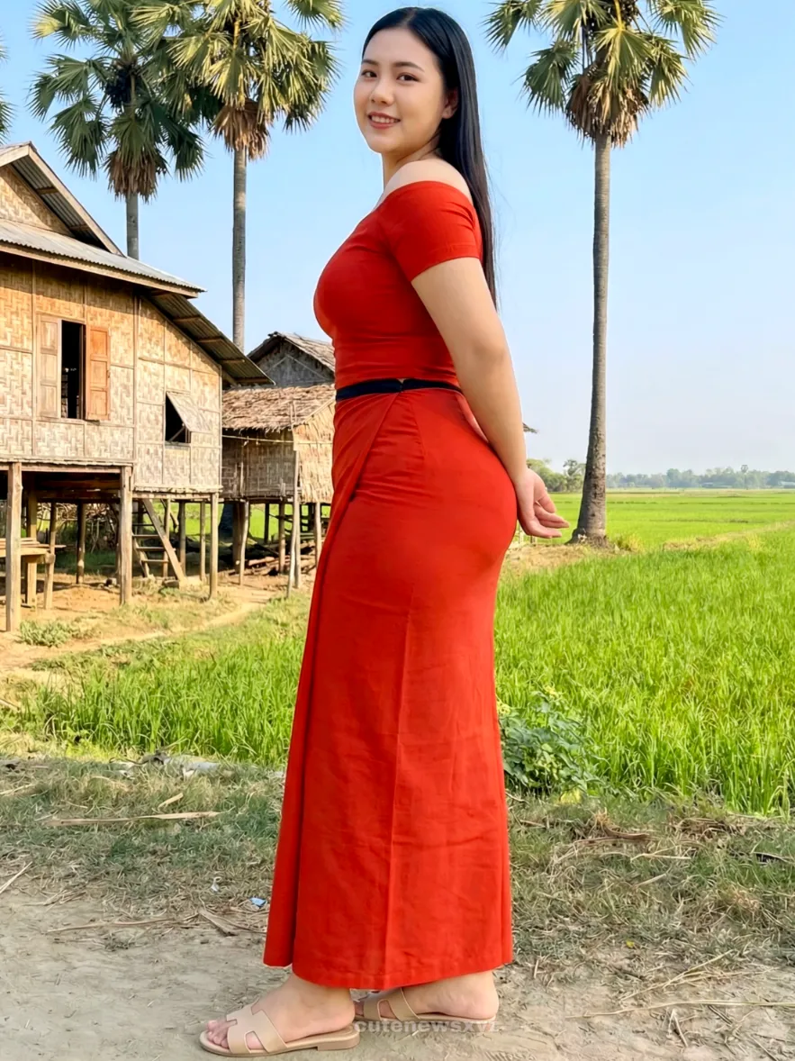 Modest standing Hands Behind (Soft & Modest) pose in Myanmar longyi, natural daylight, elegant posture, family-friendly.