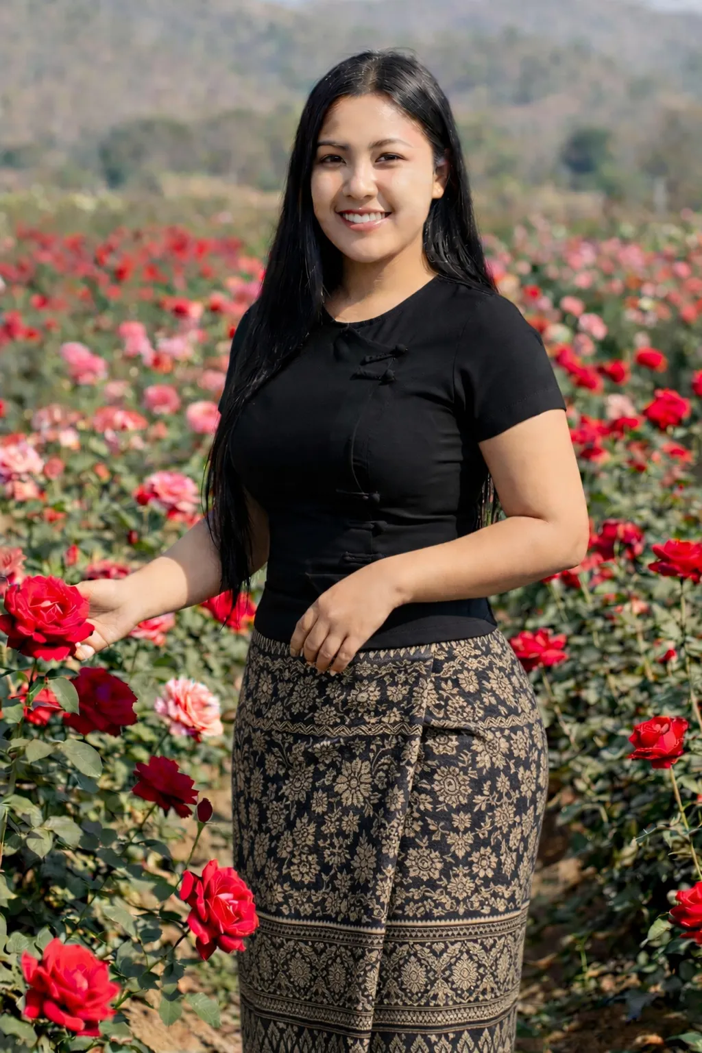 Modest Myanmar traditional outfit, Black top with Pattern htamein (Balanced), natural daylight, modest pose. 