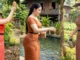 Modest village action pose in traditional outfit, [watering/feeding/picking/cleaning], soft light, family-friendly